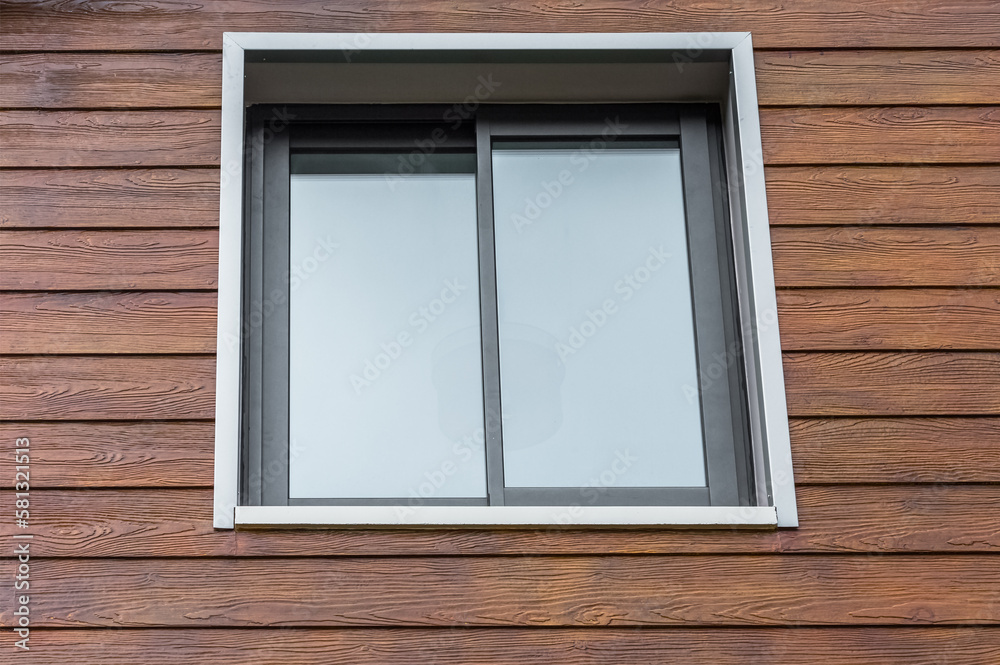 Aluminium window in a wooden wall